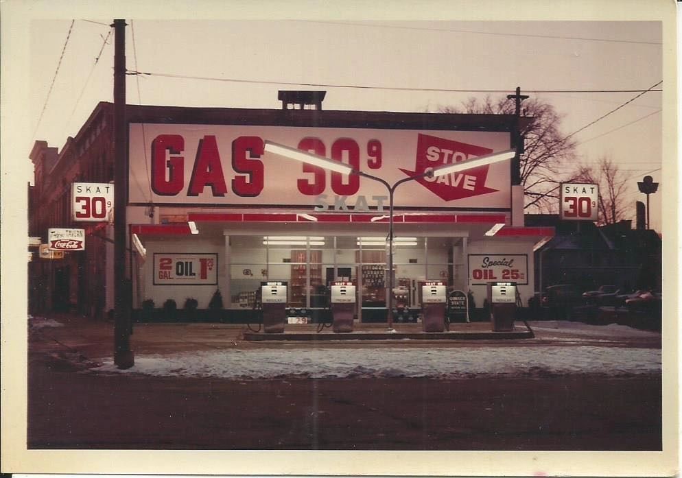 Archival photograph of the SKAT service station in winter, a large sign reading GAS 30.9 above the pumps.